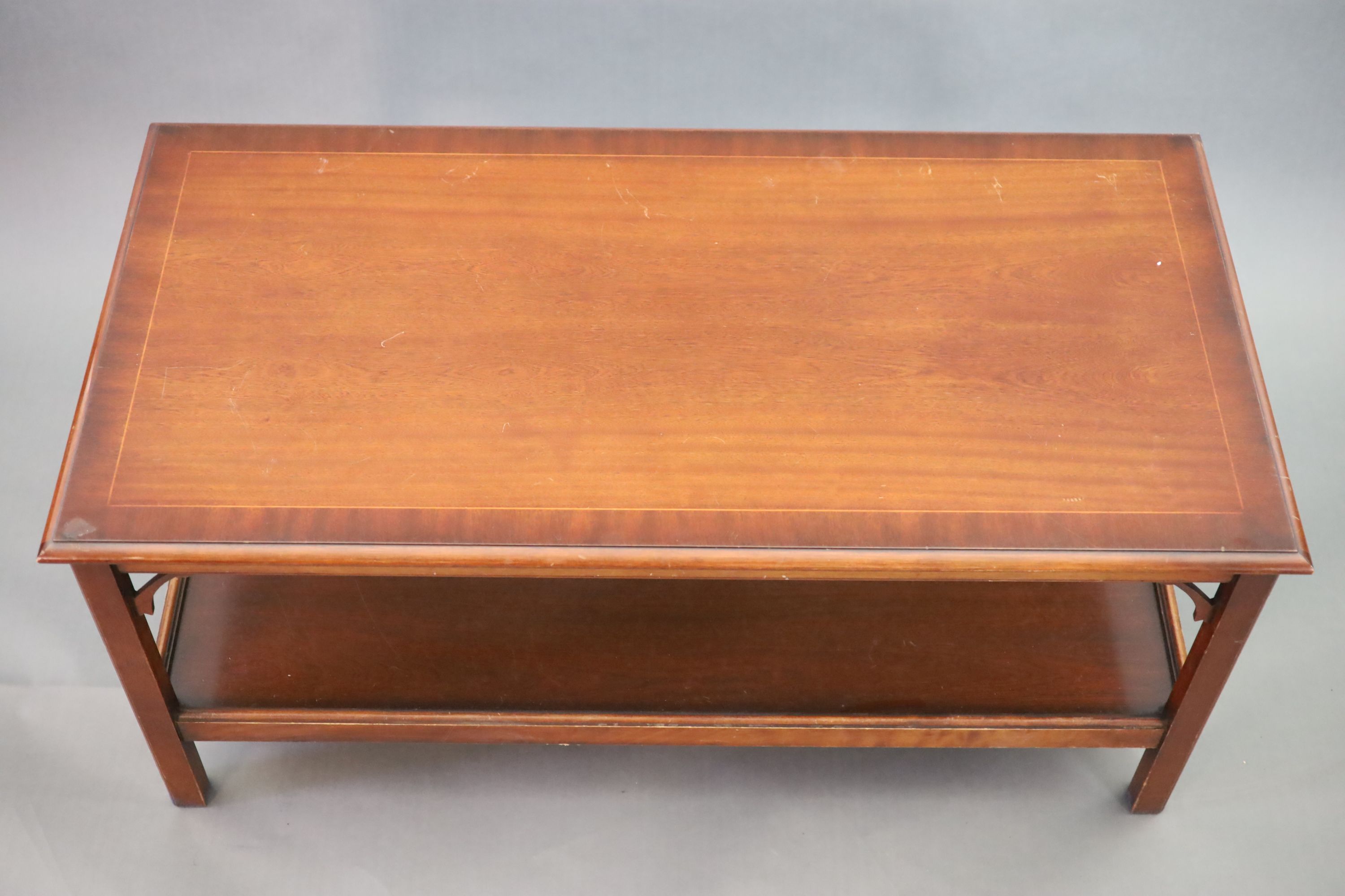 A mahogany two tier coffee table, 122 x 62cm width 122cm depth 62cm height 56cm